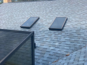 new asphalt shingle roof with two skylights in Ocala