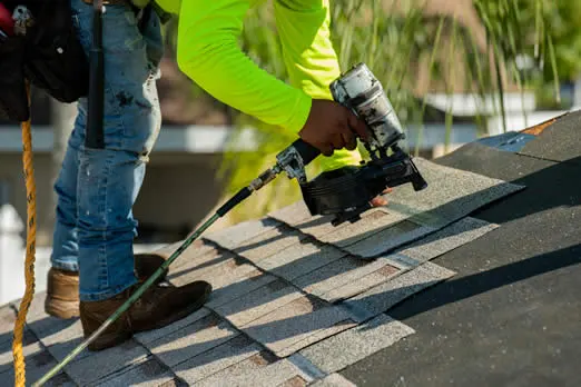 Westfall roofer installing asphalt roof shingles to a residential home in Tampa
